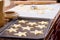 Cutting out cookies from dough with cutter and placing them on a cookie sheet