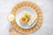 Cutting a piece of chilled savory chicken pie, a typical Brazilian dish. On the form of straw, gray wooden background. White plate