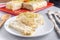 Cutting a piece of chilled savory chicken pie, a typical Brazilian dish. In a red shape, on a gray wooden background and a detail