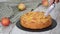 Cutting a piece of delicious apple cake with a knife.