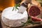 Cutting piece of fresh camembert cheese