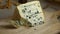 Cutting a piece of traditional French Bleu d`Auvergne cheese