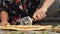 Cutting pizza with round cutter knife. Delicious cheese pizza being cut into pieces. Female slicing pizza with cutter. Cooking at