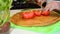 cutting red bell pepper with cleaver. Close up on the chefs hands. Healthy food preparation