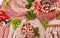 Cutting sausage and cured meat with a parsley on the white plate