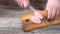 Cutting sausage on wooden chopping board