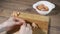 Cutting shrimp. Female hands cut boiled shrimp a large knife on a wooden cutting board.