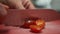 Cutting small cherry tomatoes in half. Close up view of slicing small tomatoes into halves with a knife