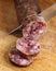 Cutting spanish salami slices with a knife