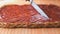 Cutting of a strawberry pie using a steel knife