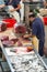 Cutting tuna steaks at fish market Mercado dos Lavradores. Funchal,