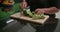 Cutting up fresh broccoli in small pieces with sharp knife