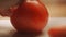 Cutting up a tomato with a knife. Cooking closeup