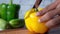 Cutting Yellow capsicum on chopping background