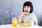 Cuttle black hair little girl having breakfast and eat lettuce