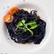 Cuttlefish black spaghetti, black pasta with cherry tomatoes