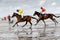 Cuxhaven, Germany - July 22, 2018: equestrian at the horse race in the mud flat at Duhner Wattrennen