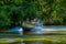 CUYABENO, ECUADOR - NOVEMBER 16, 2016: Unidentified people travelling by boat into the depth of Amazon Jungle in