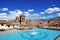 Cuzco main square by day with the Catholic religious cathedral and water fountain Peru