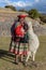 Cuzco, Peru - July 14, 2018. Peruvian woman dressed in traditional colourful clothes with alpaca / llama at Sacsayhuaman, Cusco,