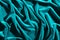 Cyan color velvet textiles for background or texture, wrinkled and shadows