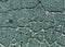 Cyan toned damaged asphalt road texture.