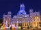 Cybele Palace and fountain illuminated at night in Madrid, Spain