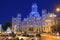 Cybele Palace and fountain illuminated at night in Madrid, Spain