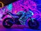 Cyber bike parked by UV graffiti mural