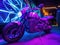 Cyber bike parked by UV graffiti mural