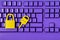 Cyber data and information security idea. Yellow padlock and key on purple keyboard. Computer, information safety, confidentiality