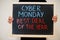 Cyber monday best deal of the year written on blackboard. Black friday concept. Boy hold board