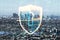 Cyber security and personal data protection concept with digital shield and keyhole inside icon on megapolis city skyline