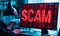 Cybersecurity threat concept with the word SCAM in bold red letters on a computer screen, signifying internet fraud, hacking