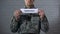 Cyberwar word written on sign in hands of male soldier, information security