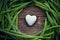 Cycle frame of leaf and white heart shape sign on wood table