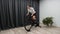 Cycle indoors at home on stationary bicycle trainer woman pedaling out of saddle as a part of race preparation. Pro cycling