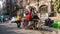 A cycle rickshaw with an idol of a Goddess riding past an old vintage building in the Kumartuli area of the city of Kolkata