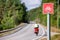 Cycle route sign with traveling cyclist in background Southern N