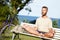 He cycled to his meditation spot. a mature man meditating on a park bench.