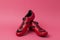 Cycling Concepts. Pair of New Red Cycling Shoes Placed Together Over Pink Coral Background