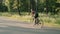 Cycling hard training. Cyclist intensively pedaling on bicycle, doing cardio exercises. Woman training on bike. Outdoor cycling tr