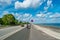 Cycling lane along sea bank and beach and lonely cyclist on bicycle in Copenhagen, Denmark