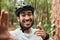 Cycling man, selfie and smile in forest, pointing and portrait for wellness, training and blog on adventure. Influencer