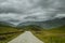 Cycling mountain road. Misty mountain road in high mountains.. Cloudy sky with mountain road