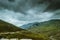 Cycling mountain road. Misty mountain road in high mountains.. Cloudy sky with mountain road