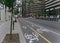 A cycling path at a side of a street with a background of the bicycle sharing station Bixi