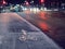 Cycling path under frost in focus. City traffic lights out of focus. Dangerous road conditions in winter time concept. Selective