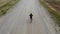 Cycling road bike, bicycle rider from top, aerial view, shot from above, man cyclist on empty road