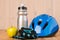 cycling - set of objects for playing sports on a wooden background - helmet, gloves, water bottle and apple